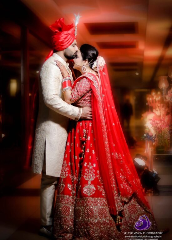 a man and woman in traditional indian attire kissing